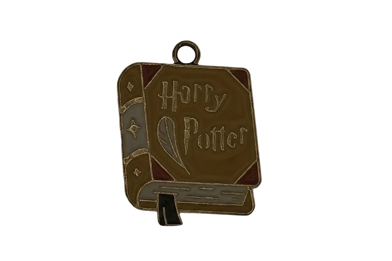 Enamel book-shaped charm with quill and 'Harry Potter' text on a black background.