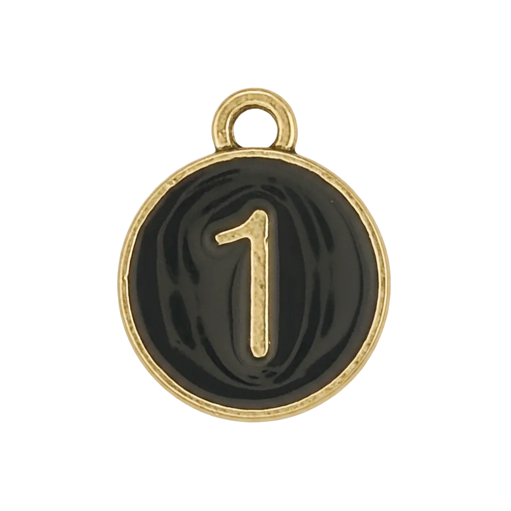Close-up of a small round black charm with a gold number 1 and border.