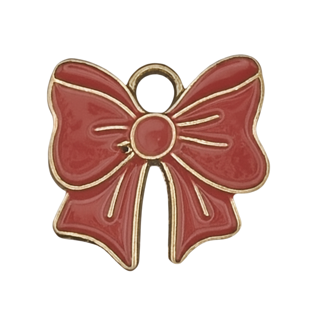 close-up of red enamel bow charm with gold outline on black background