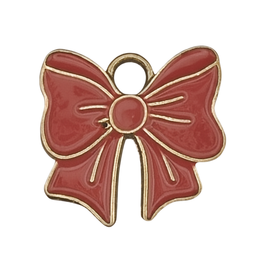 close-up of red enamel bow charm with gold outline on black background
