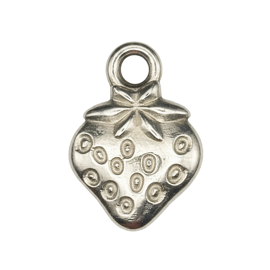 close-up of silver strawberry charm with engraved seeds on black background