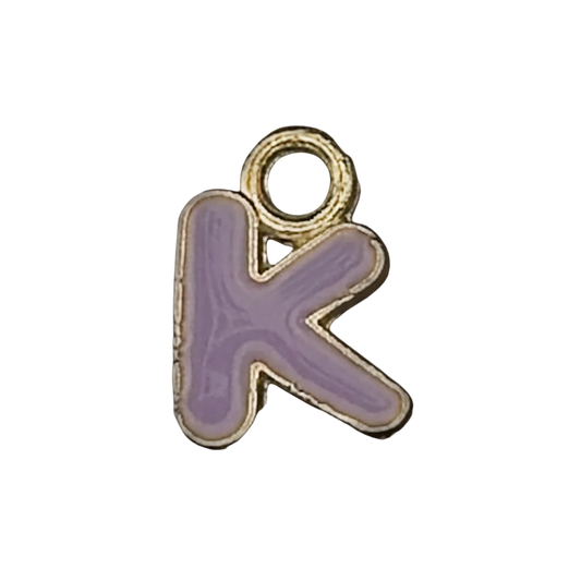 Close-up of purple letter K charm with gold-tone edge on a black background.
