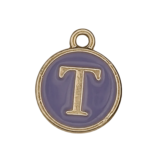 close-up of round purple enamel charm with gold letter T