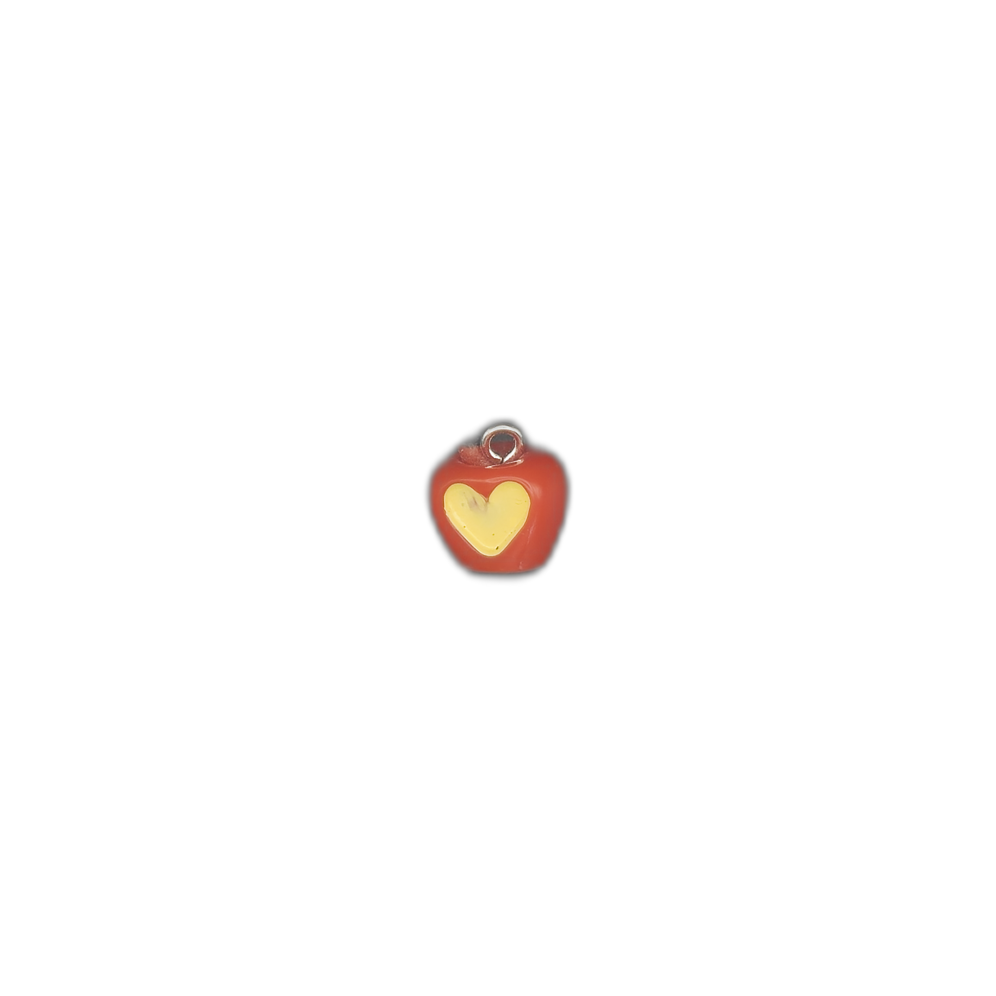 small red apple charm with yellow heart on a black background