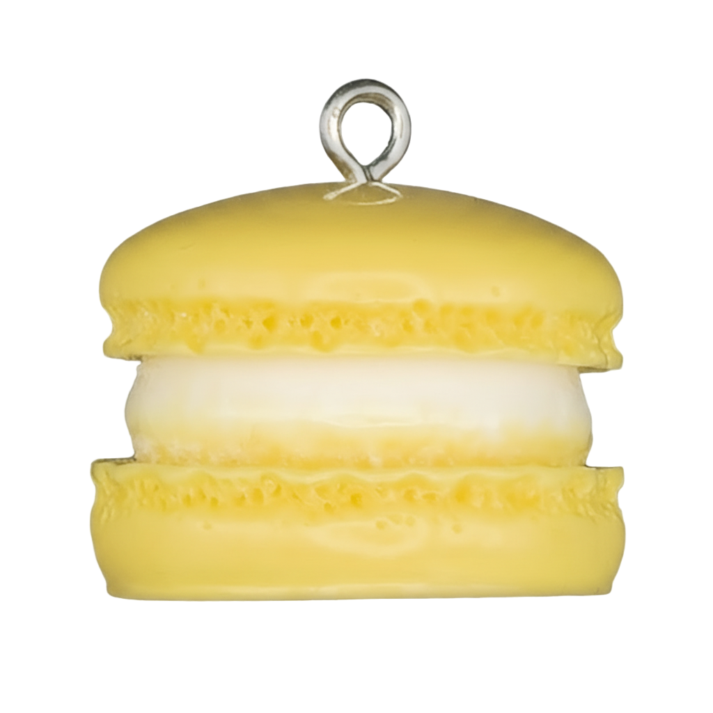 close-up of a yellow macaron charm with white filling on a black background