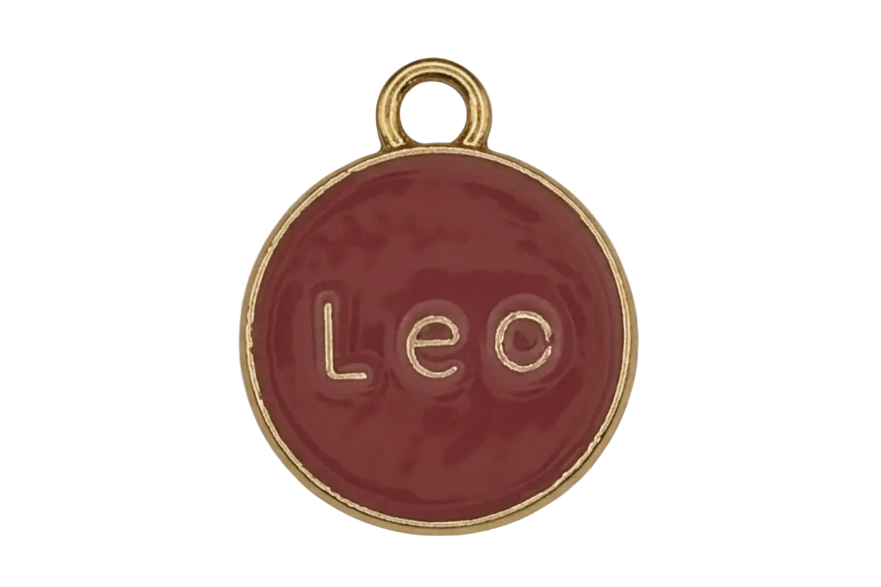 close-up of red round 'Leo' enamel charm with gold rim and loop on a black background