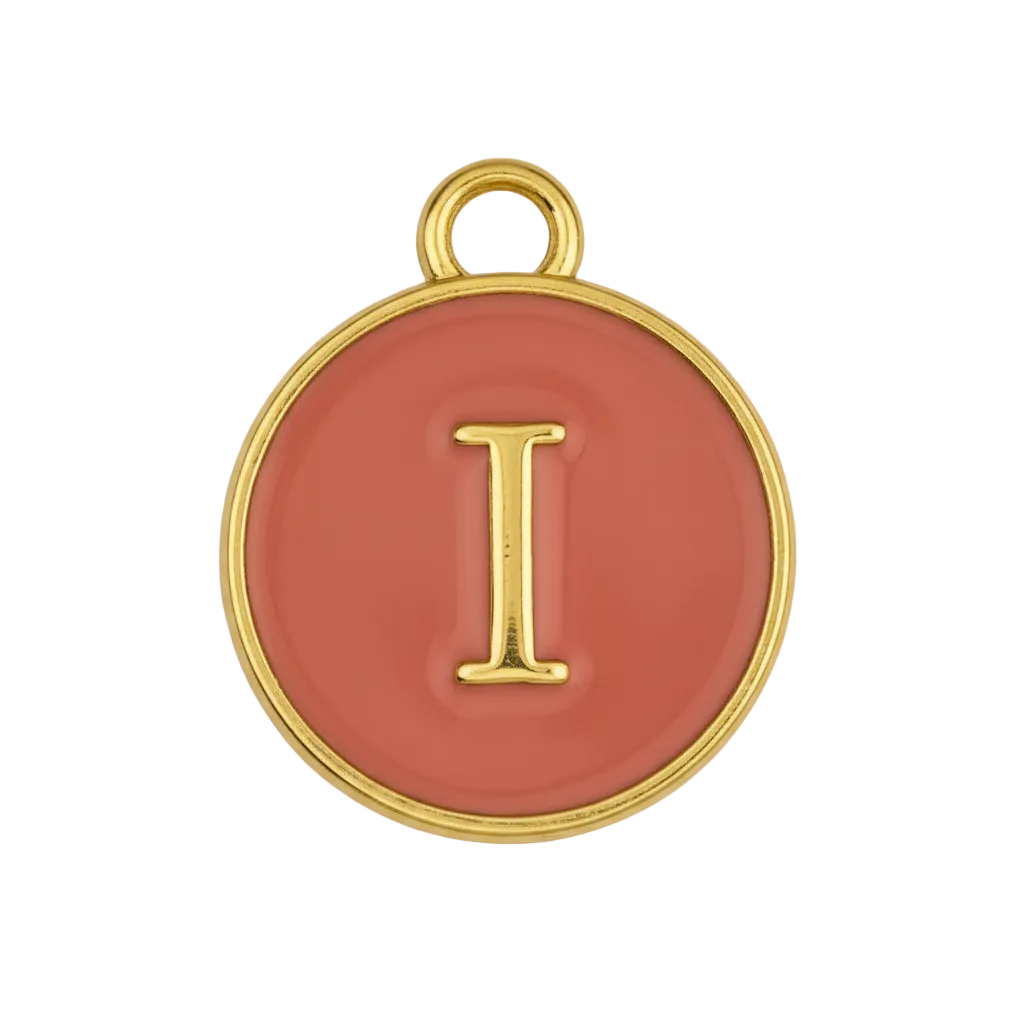 close-up of round red enamel charm with gold letter I