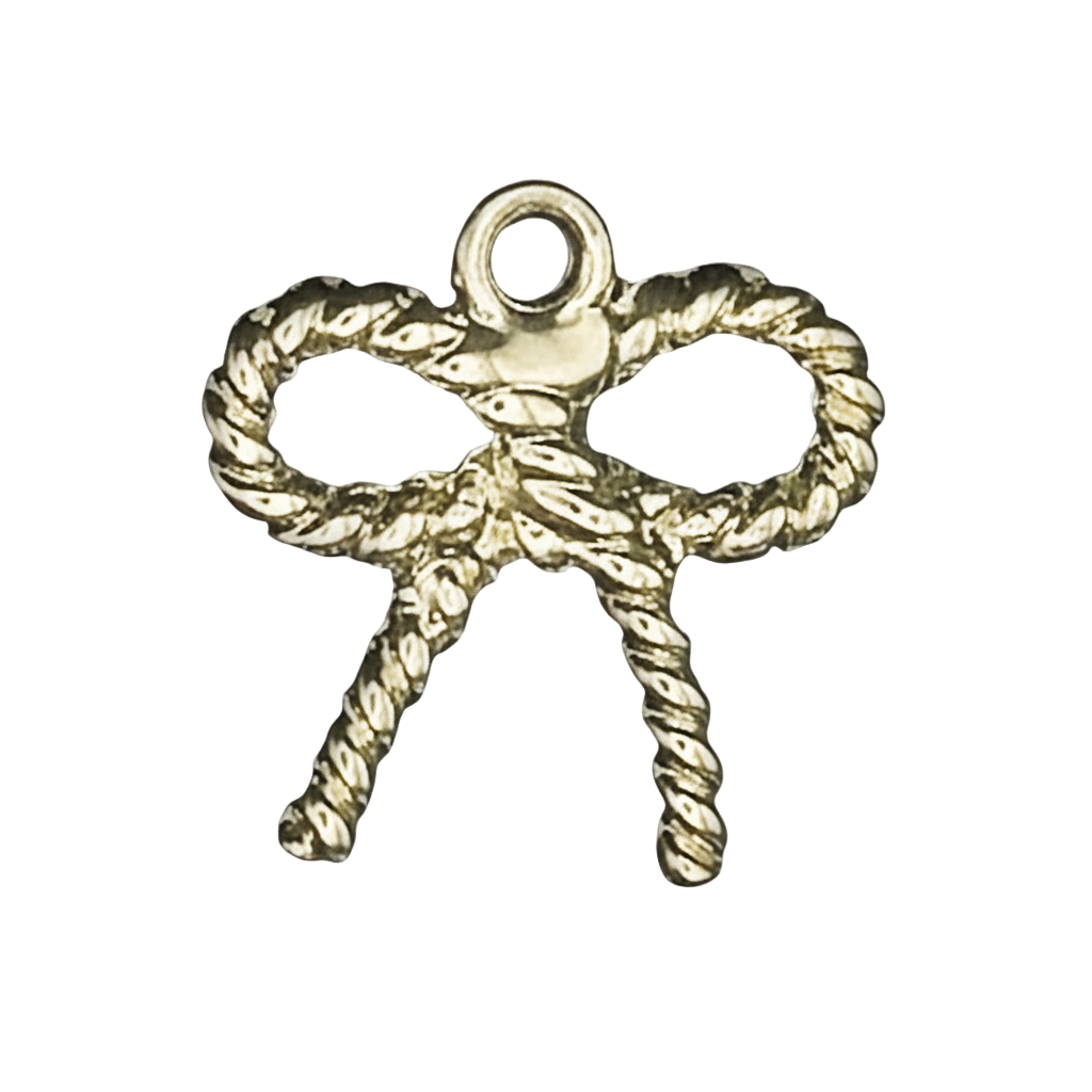 close-up of a small gold-tone rope bow charm on a black background