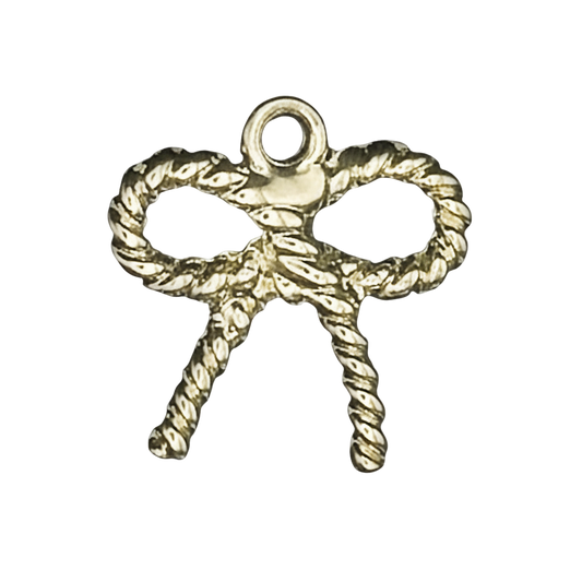 close-up of a small gold-tone rope bow charm on a black background