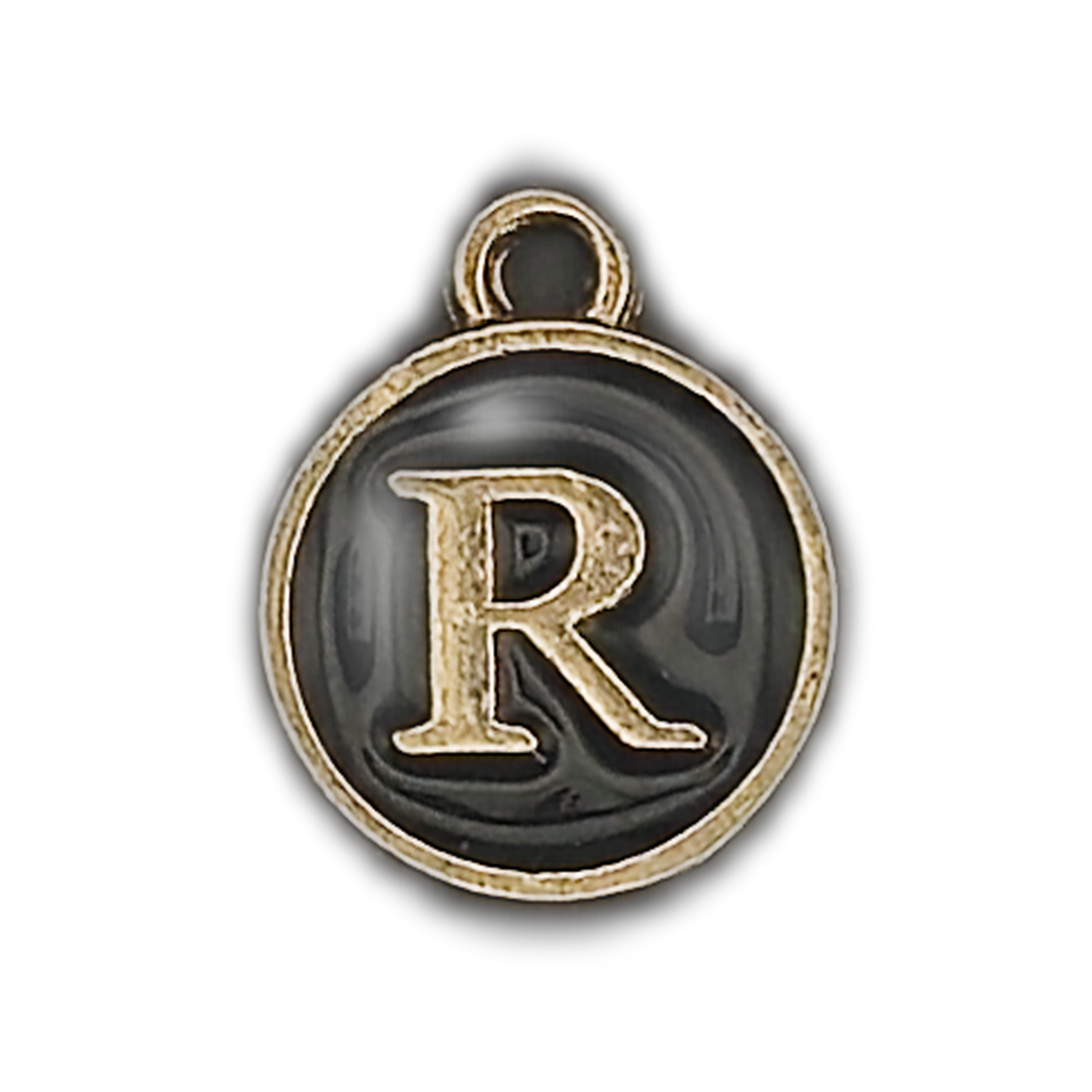 close-up of round black enamel charm with raised gold letter R