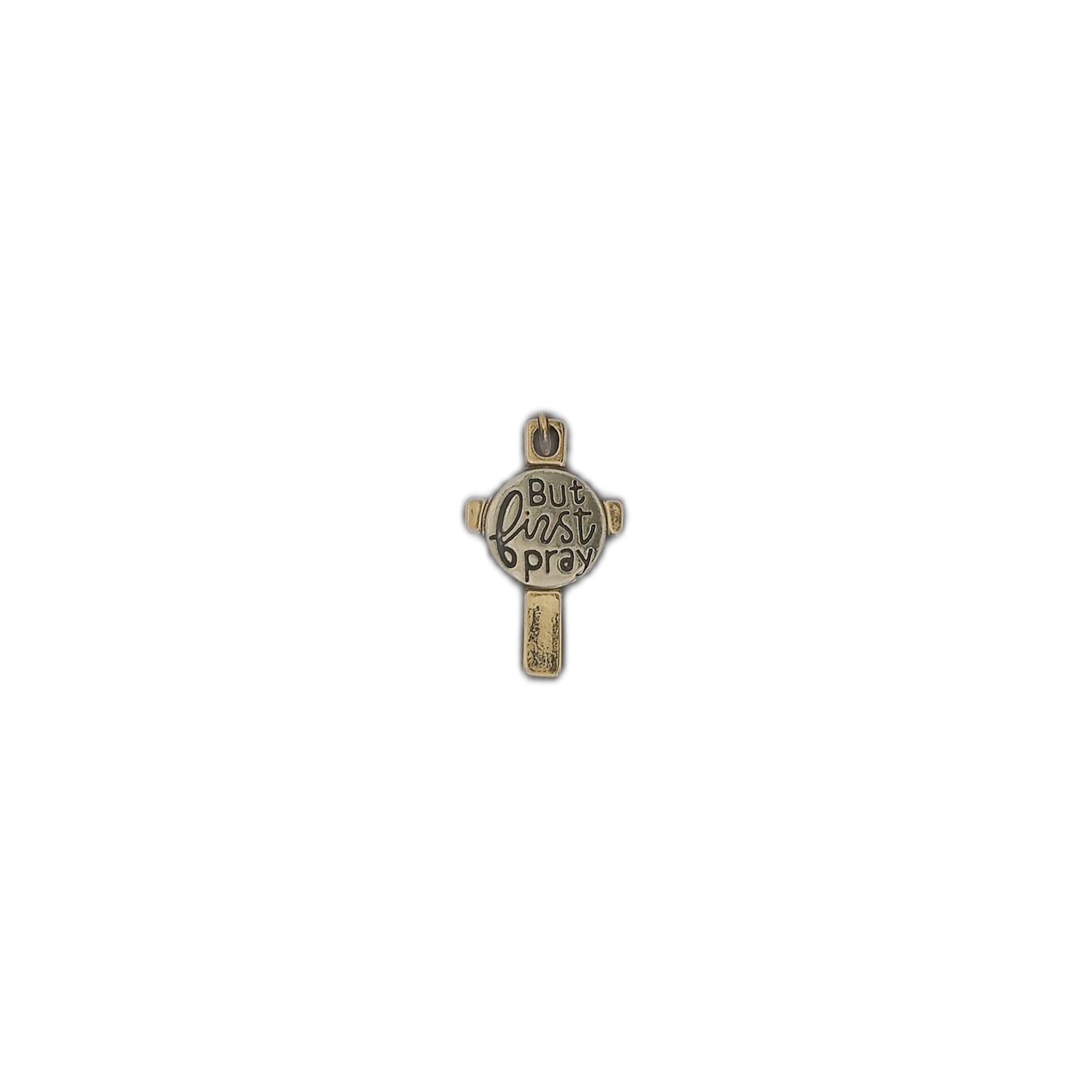 small two-tone cross charm reading 'But first pray' on a black background