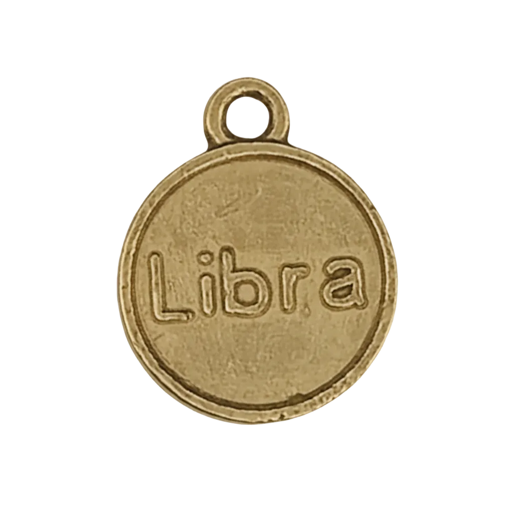 close-up of round gold-tone charm engraved with the word Libra