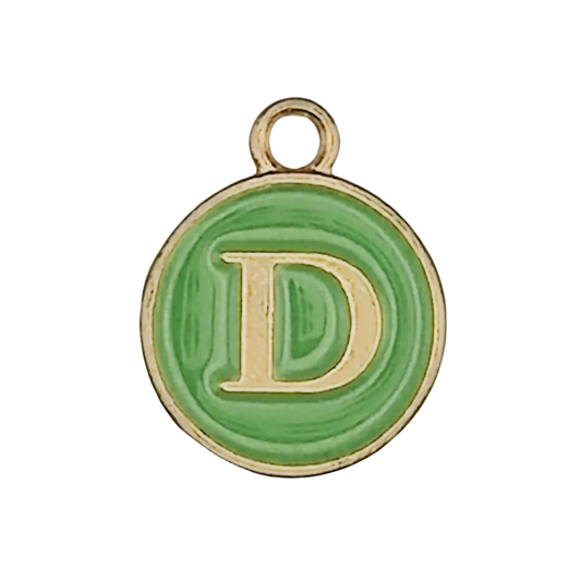close-up of round green enamel charm with gold letter D