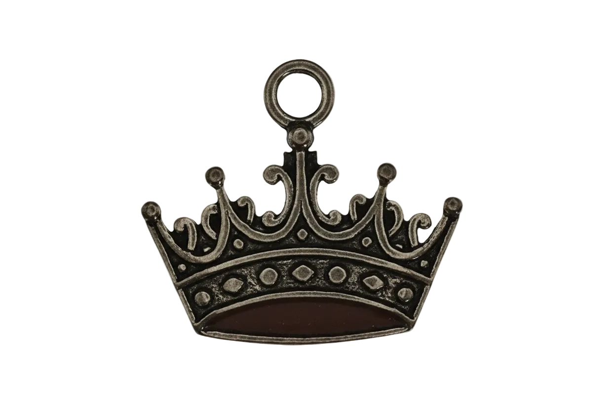 close-up of antique gold crown charm on black background