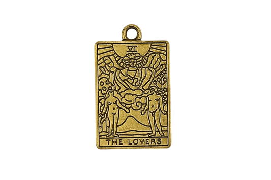 gold rectangular tarot card charm reading The Lovers, close-up on black background