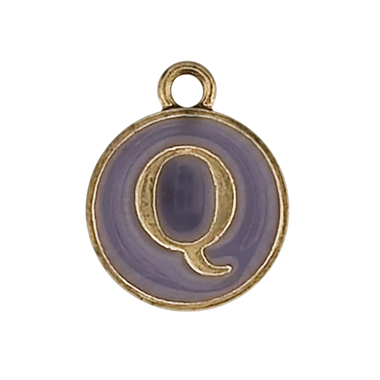 close-up of round purple enamel charm with gold letter Q on black background