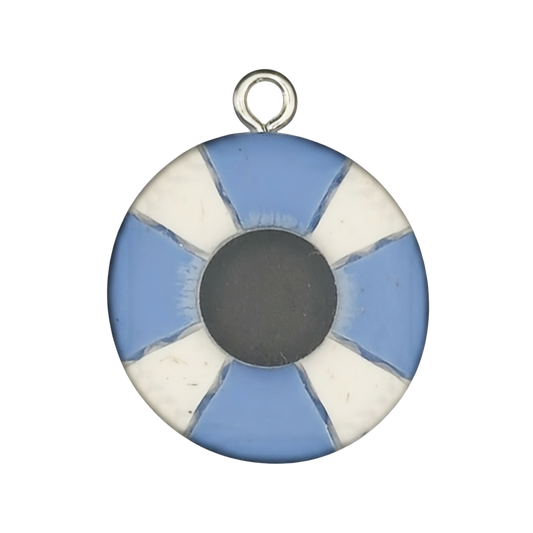close-up of round blue and white lifebuoy charm with dark center on black background