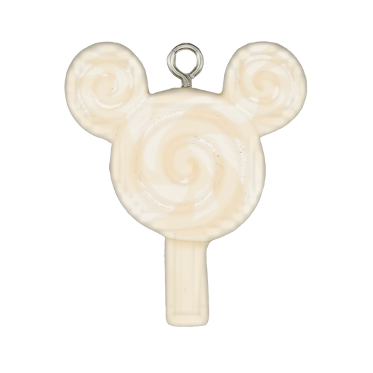 close-up of cream and white swirl lollipop charm with two round ear-like tops on a black background