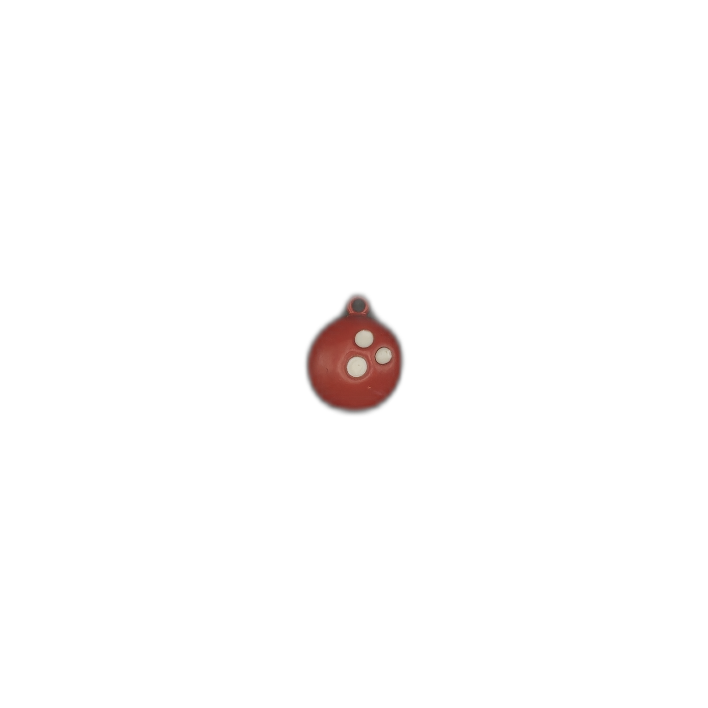 Small red bowling ball charm with three white finger holes on a black background.