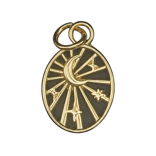 close-up gold oval charm with crescent moon, stars, and rays on a black background