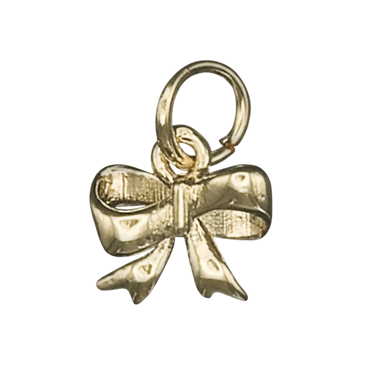 close-up of a small gold bow charm on a black background