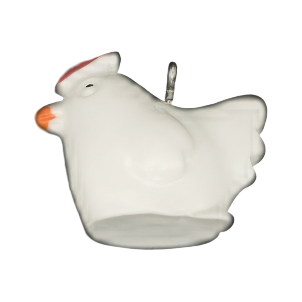 close-up of white chicken charm with red comb and orange beak on black background
