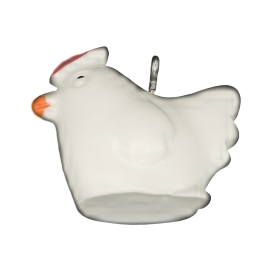 close-up of white chicken charm with red comb and orange beak on black background