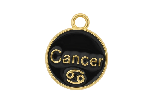 close-up of round black enamel charm with the word 'Cancer' in gold