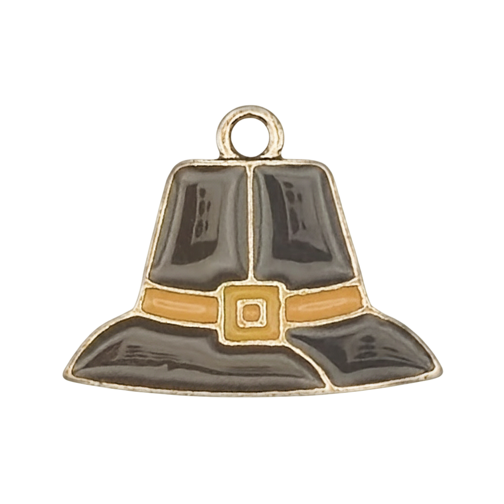 close-up of black and gold enamel pilgrim hat charm on a black background