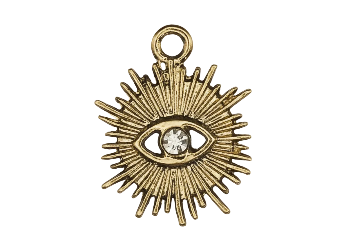close-up of gold-tone sunburst eye charm with clear center stone on black background