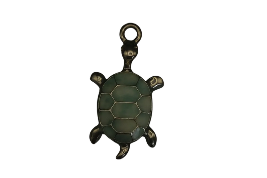 close-up of green enamel turtle charm on black background