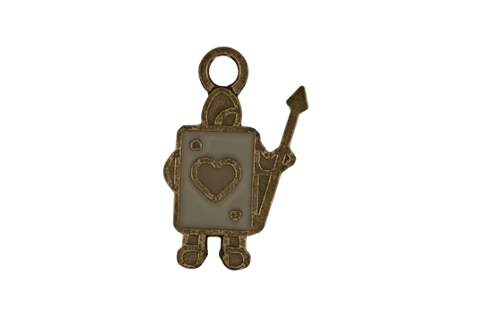 close-up of a gold-tone playing card soldier charm with heart emblem and spear on a black background