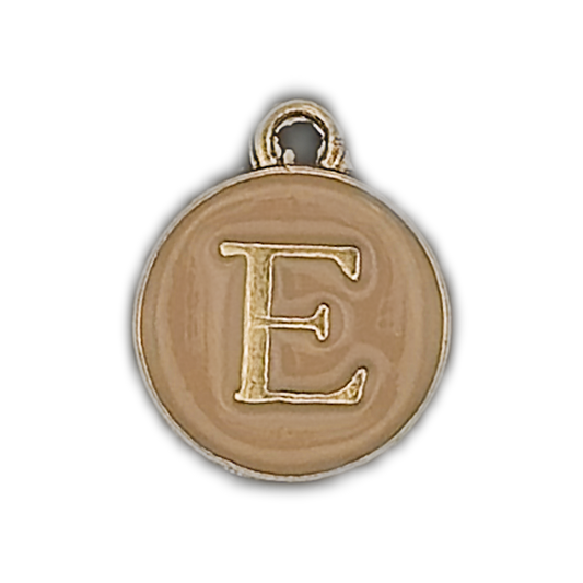 close-up of round gold-tone charm with letter E on a beige face