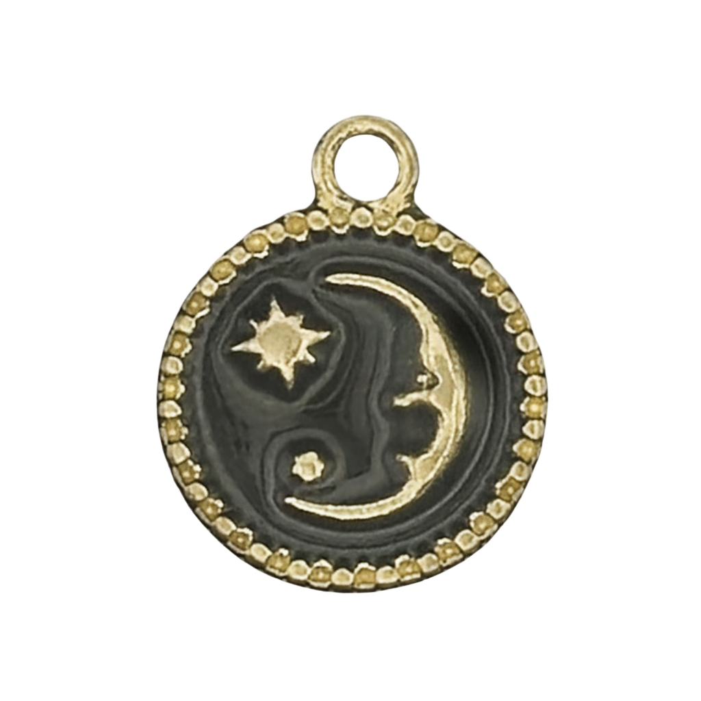 close-up of round black enamel charm with gold crescent moon and stars and beaded border