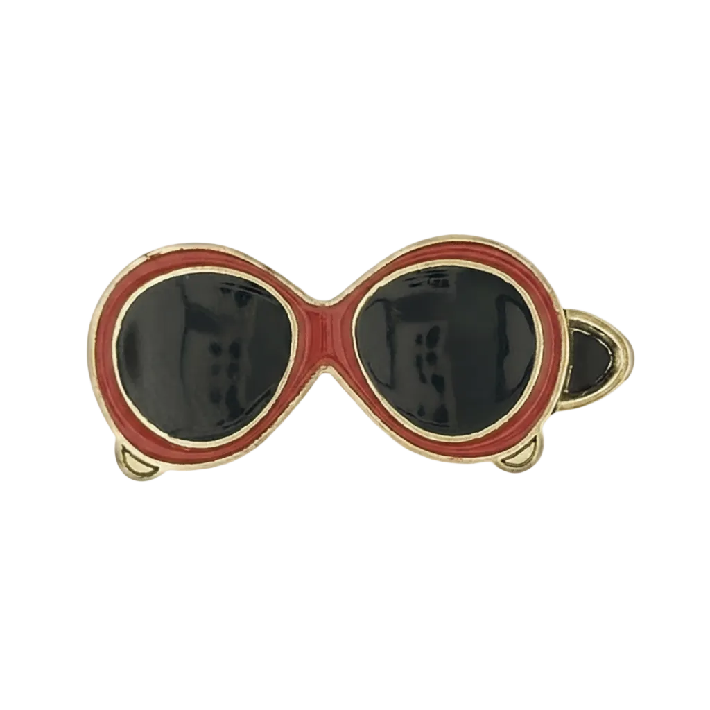 close-up of red sunglasses enamel charm with black lenses and gold outline on a black background
