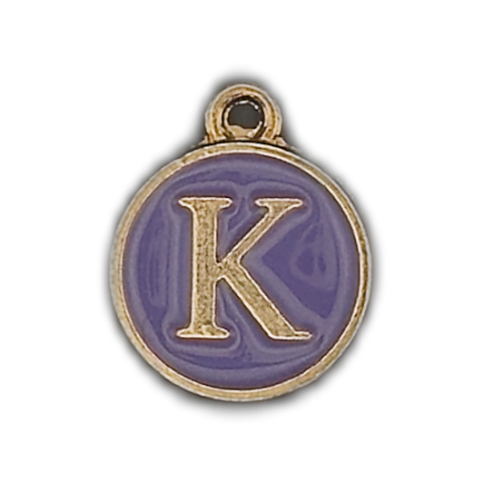 close-up of round purple enamel charm with gold letter K