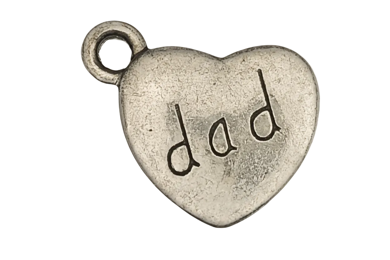 close-up silver heart charm with 'dad' text on black