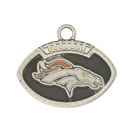 close-up of silver-tone football-shaped charm with stylized horse head on black enamel