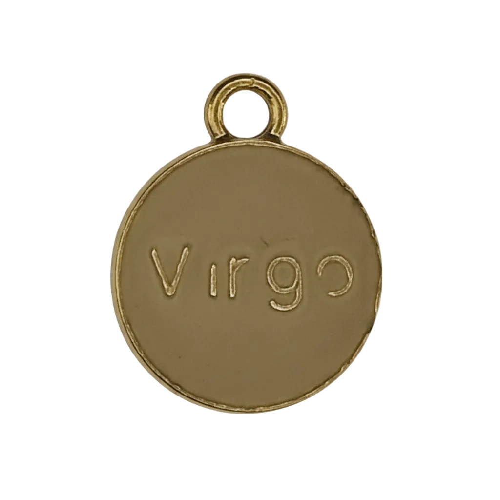 close-up of a round gold-tone charm engraved with Virgo on a black background