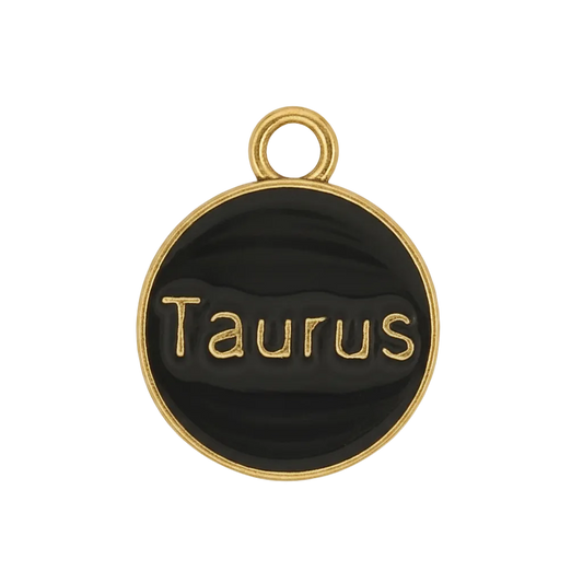 close-up of round black and gold Taurus charm