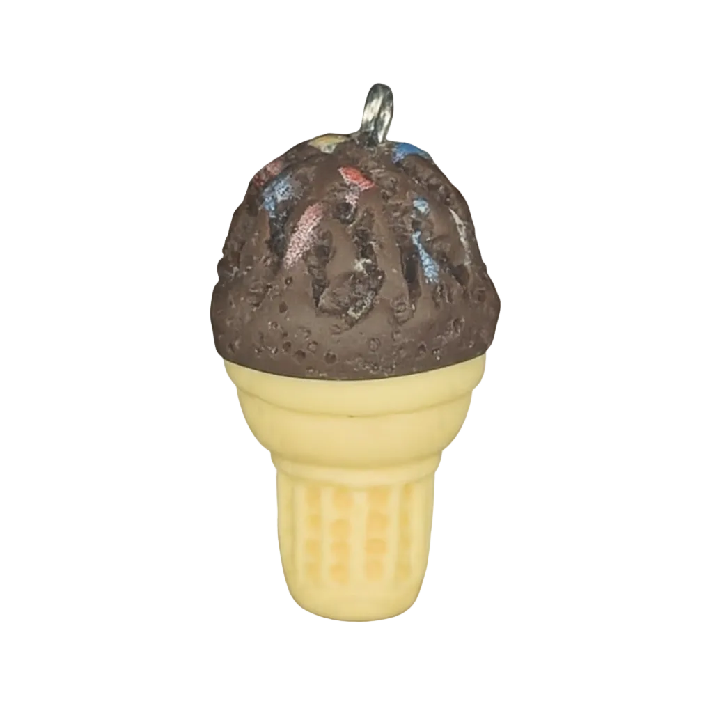close-up of miniature chocolate ice cream cone charm with beige cone on black background