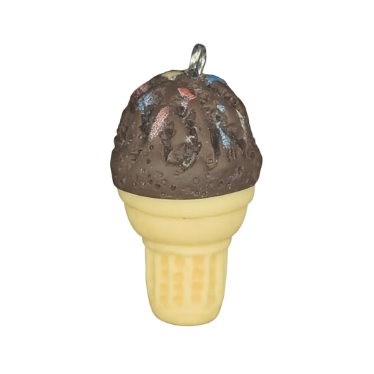 close-up of miniature chocolate ice cream cone charm with beige cone on black background