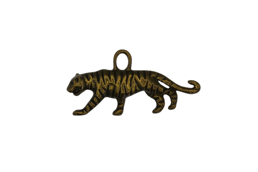 close-up of a gold-tone tiger charm on a black background