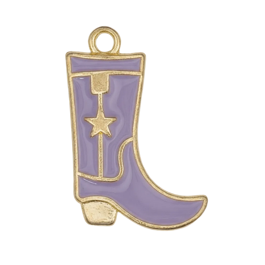 Close-up of a purple cowboy boot charm with gold-tone outline and star motif on a black background.