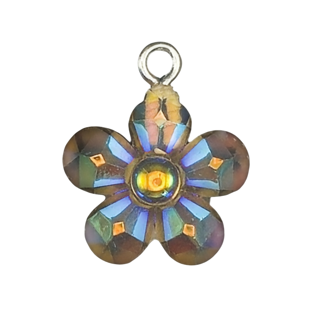 close-up of small iridescent glass flower charm on black background