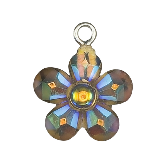 close-up of small iridescent glass flower charm on black background