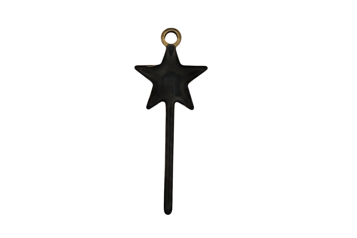 close-up of a black shooting star charm with a trailing tail