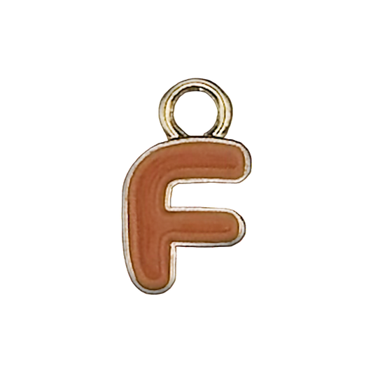 close-up of an orange letter F charm with a gold outline on a black background