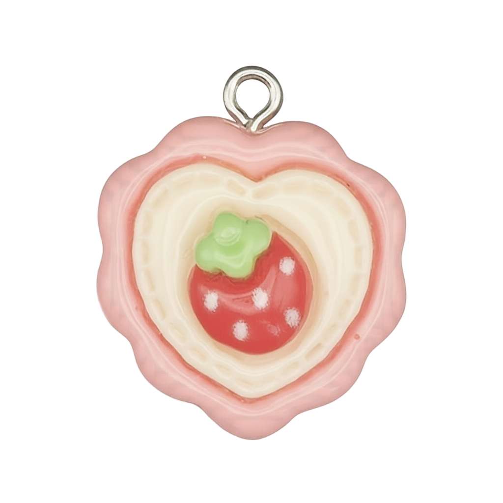 Close-up of pink heart cookie charm with a strawberry center on a black background.