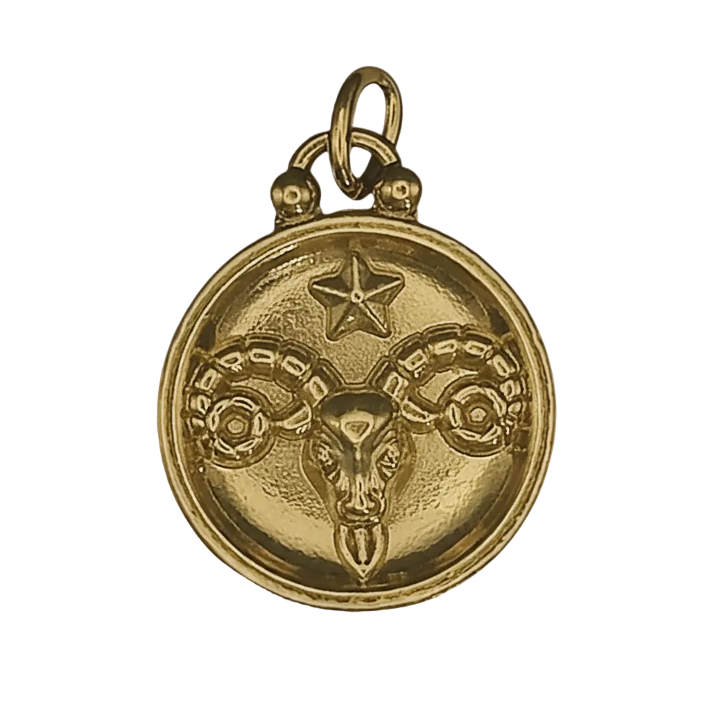 close-up of a gold round charm with a ram head and star motif on a black background